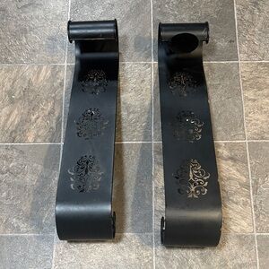 black metal wall sconces or scroll decor pieces,